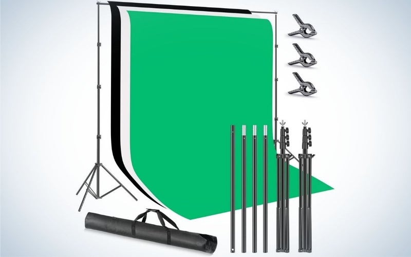 A square green field with some black sticks of different sizes and a bag that you can put inside the products for the next shot.