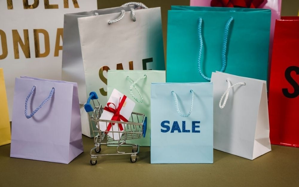 A lots of paper bags with with and light blue color with sale written into them.