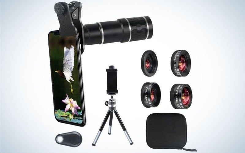 A black smartphone holder all with a cell case with a flower and a striped stork, as well as four different lenses, a three-legged holder and a small black square bag.