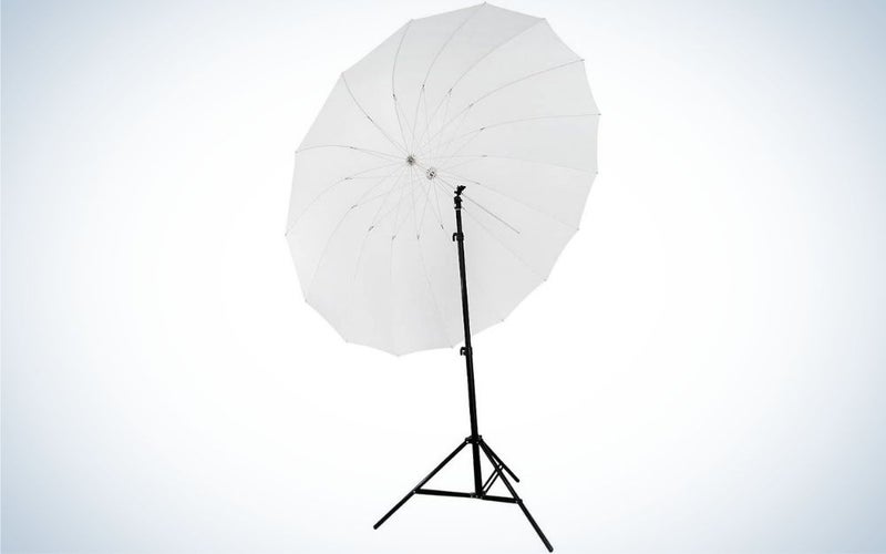 A large white umbrella with a thin stick holding a few black colored legs.