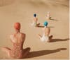 models-sitting-on-sand-dunes