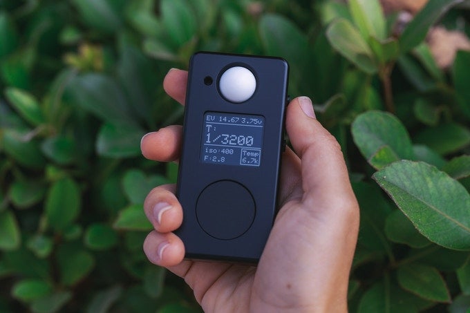 Negative Supply LM1 Light Meter in a hand in front of some plants