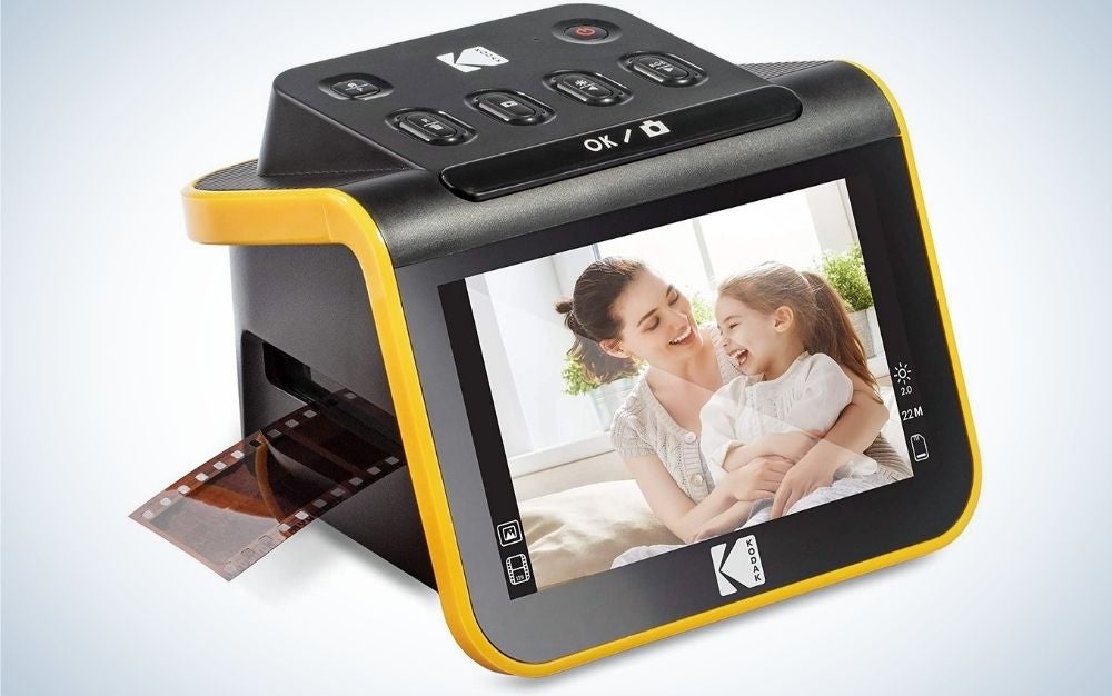 A black scanner with a small front screen and a photo on it, all black and with a thick yellow line on the back.