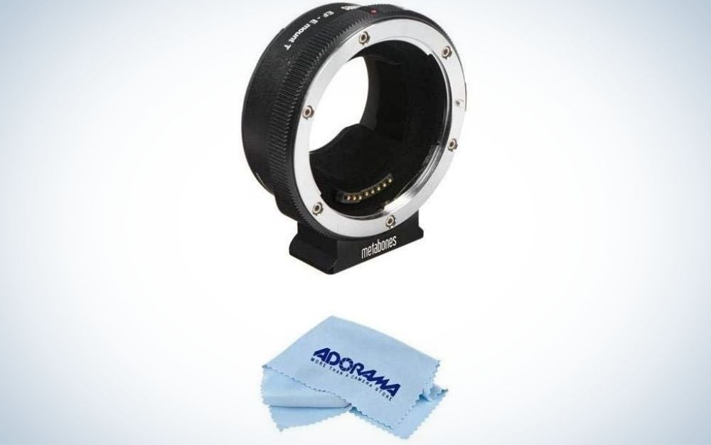 A black lens adapter all with an oval shape and empty space on the inside as well as a blue cloth to clean the lenses.