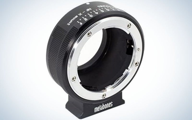 An all-black lens adapter with an oval shape and empty space on the inside as well as a silver arched line around the lens.