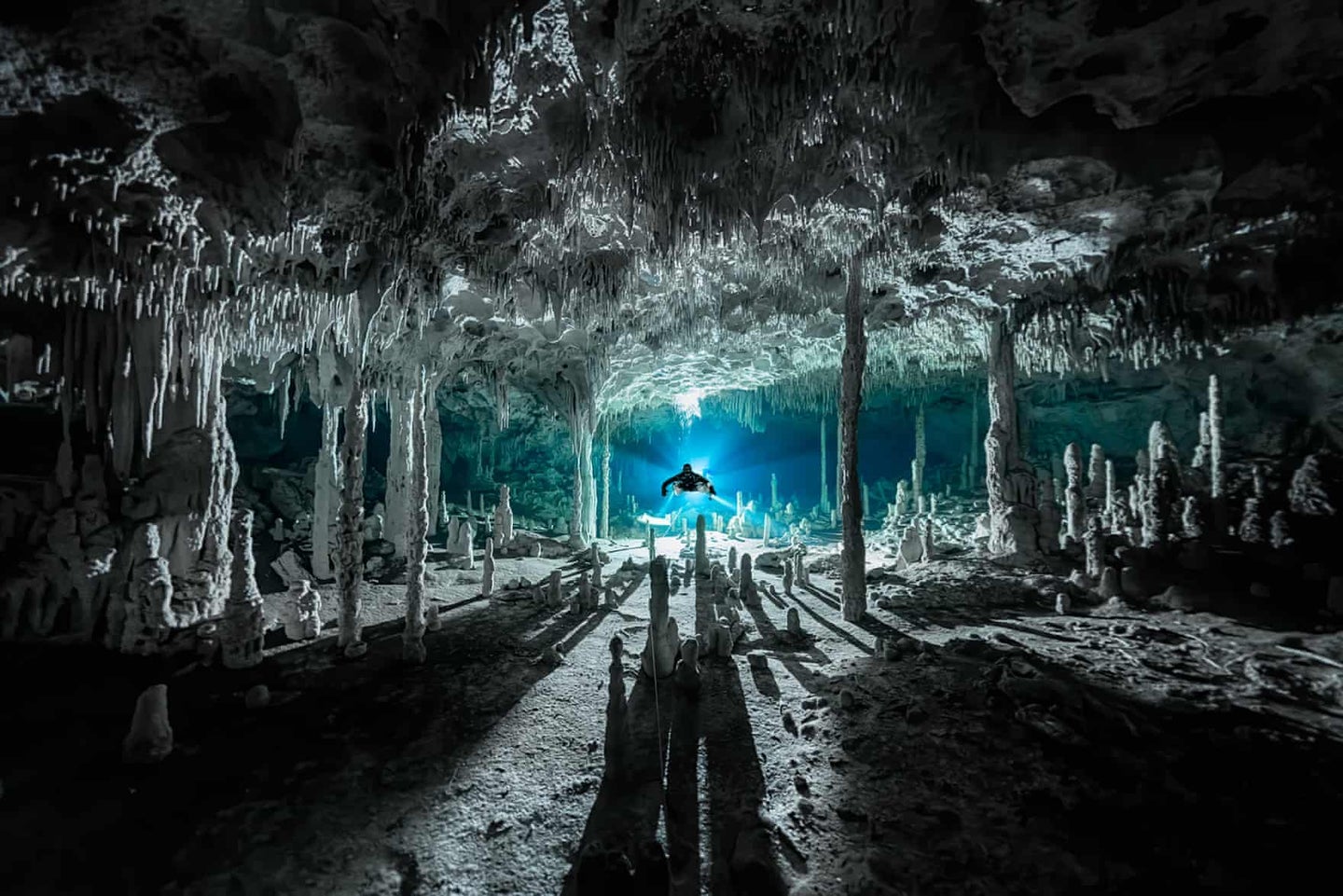 Speleothems cast long shadows at Cenote dos Pisos in Mexico