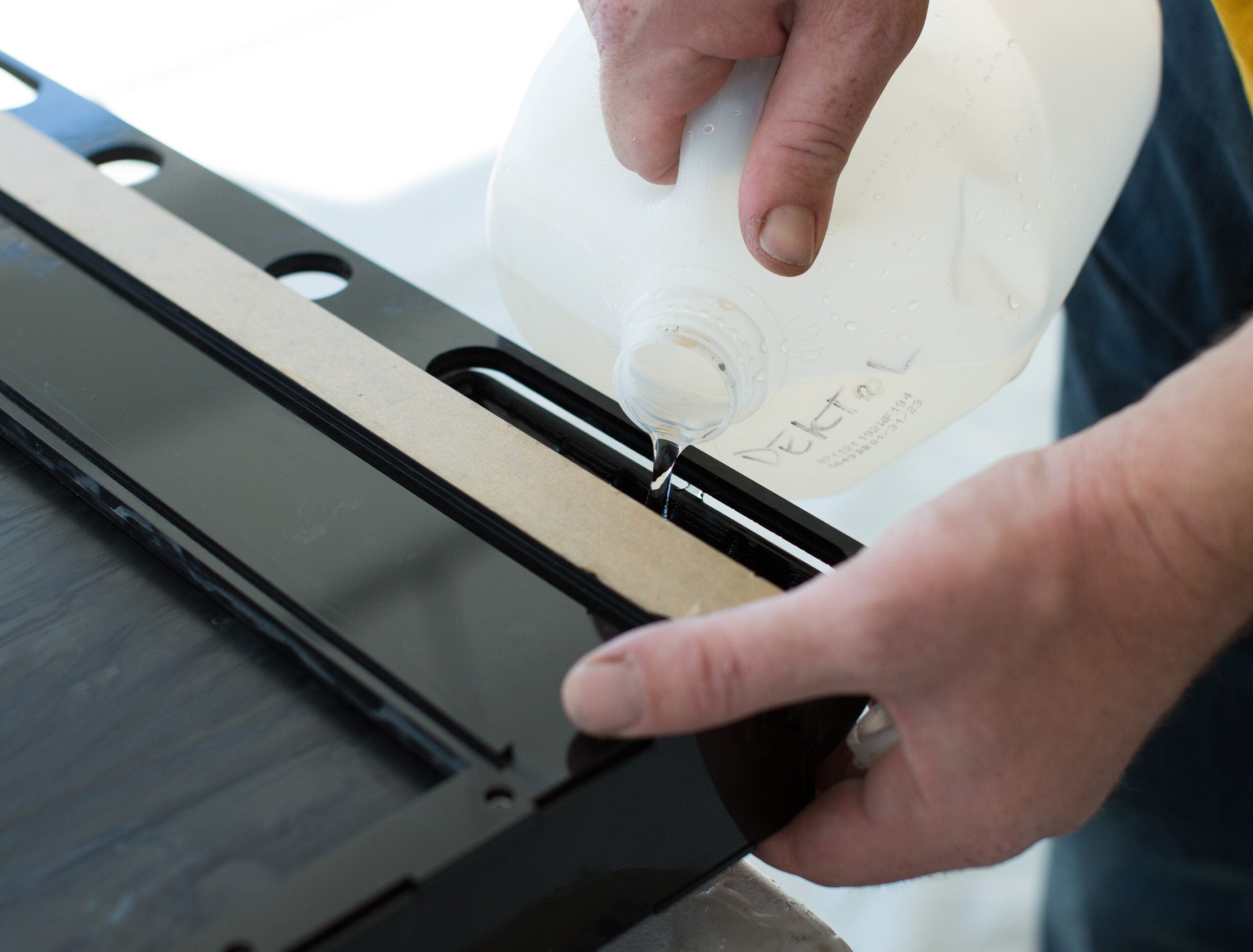 Moses pouring chemistry into the film holder to make a positive print.