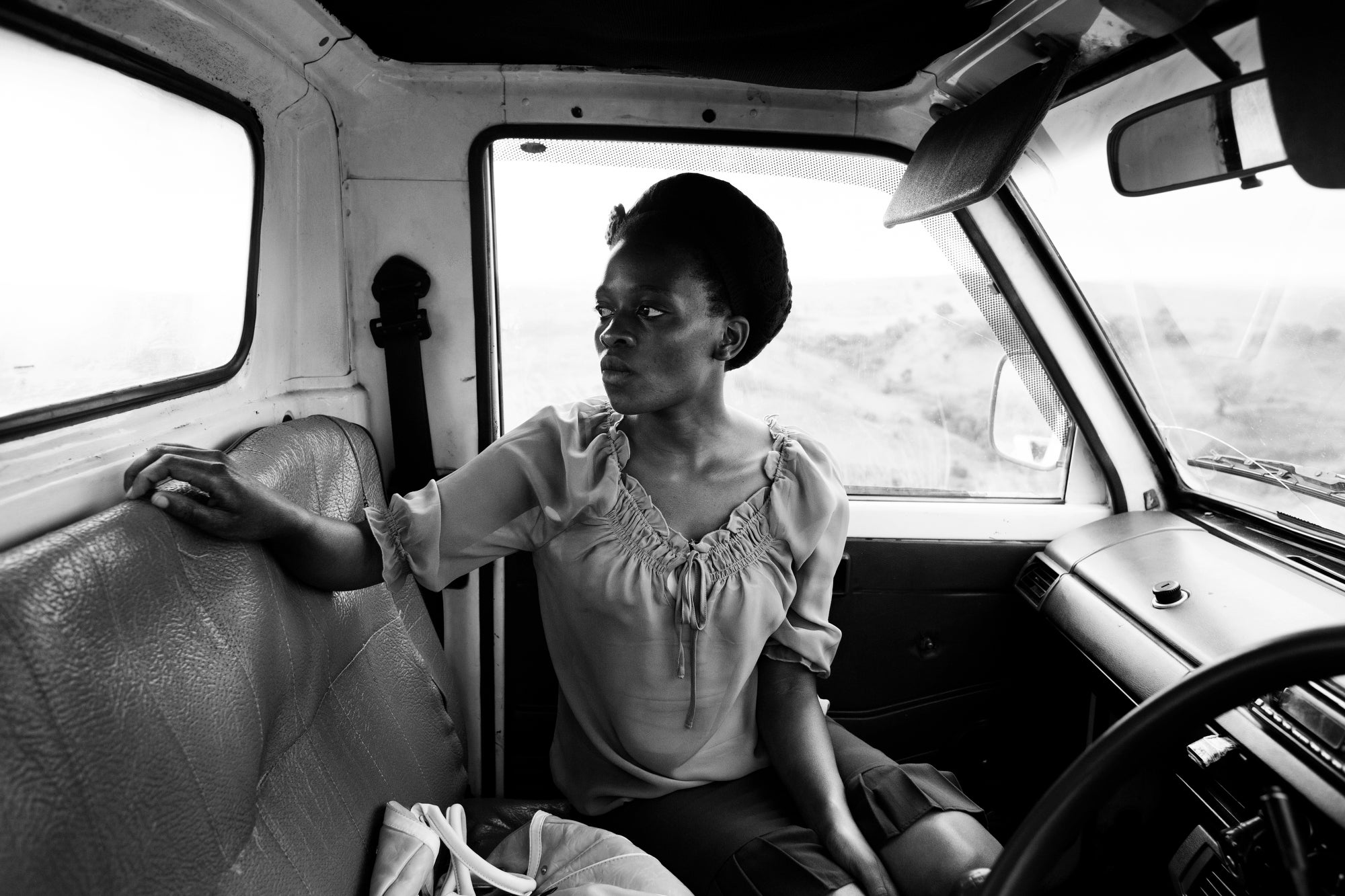 Lisa, 22, looks out at the houses marked for destruction near her home in Inanda, outside Durban, South Africa. She lost both of her parents to the AIDS epidemic before she was twelve, and has since tended to her familyÃs estate. When the government tried to bulldoze her two rondavels and one two-room house and move her into a transit camp, she joined the shack-dwellerÃs organization Abahlali baseMjondolo.