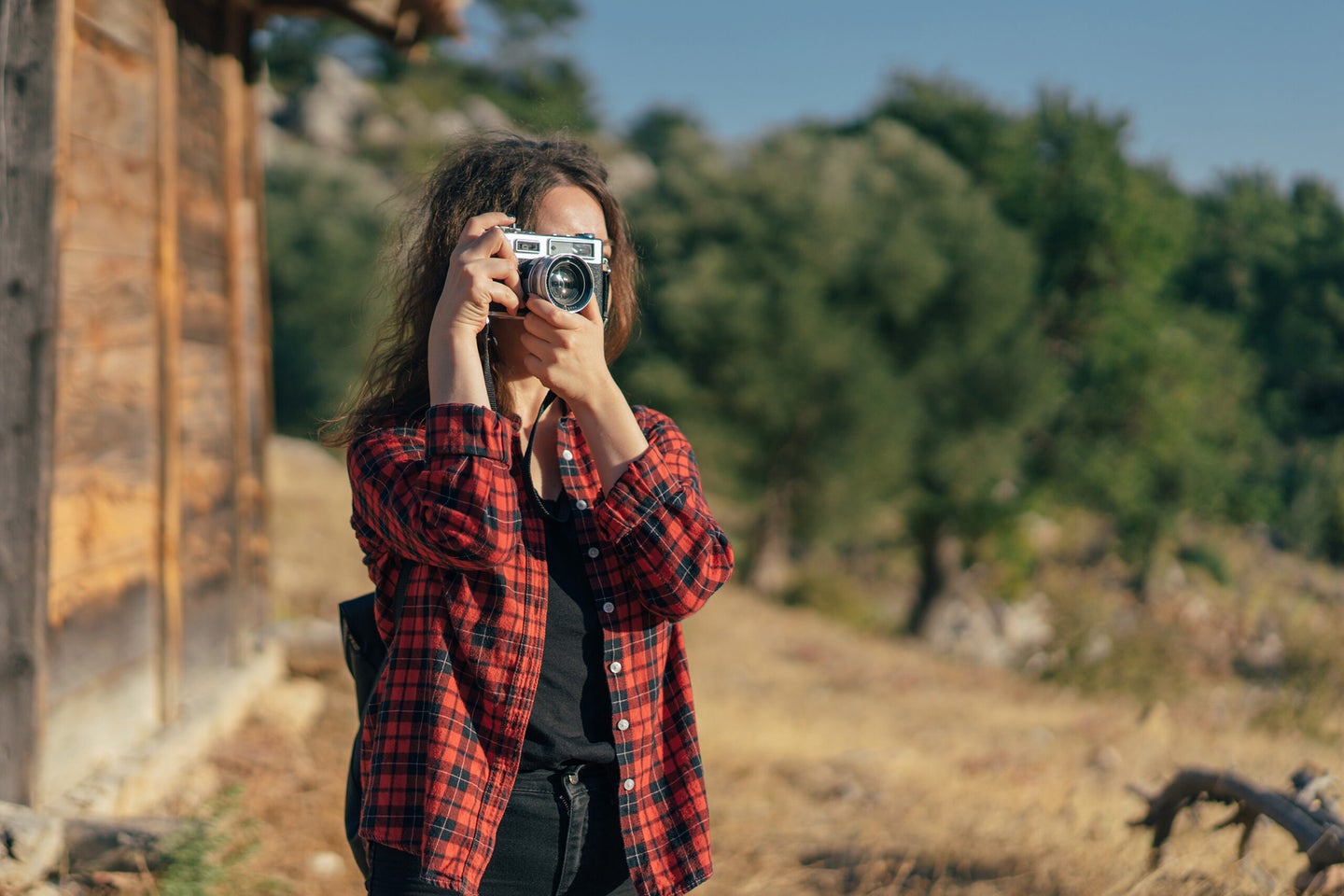 Young woman photographing the autumn season