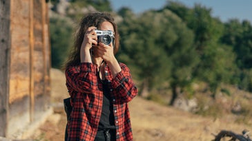 Young woman photographing the autumn season
