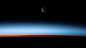 A crescent moon and sunset, captured from the ISS.