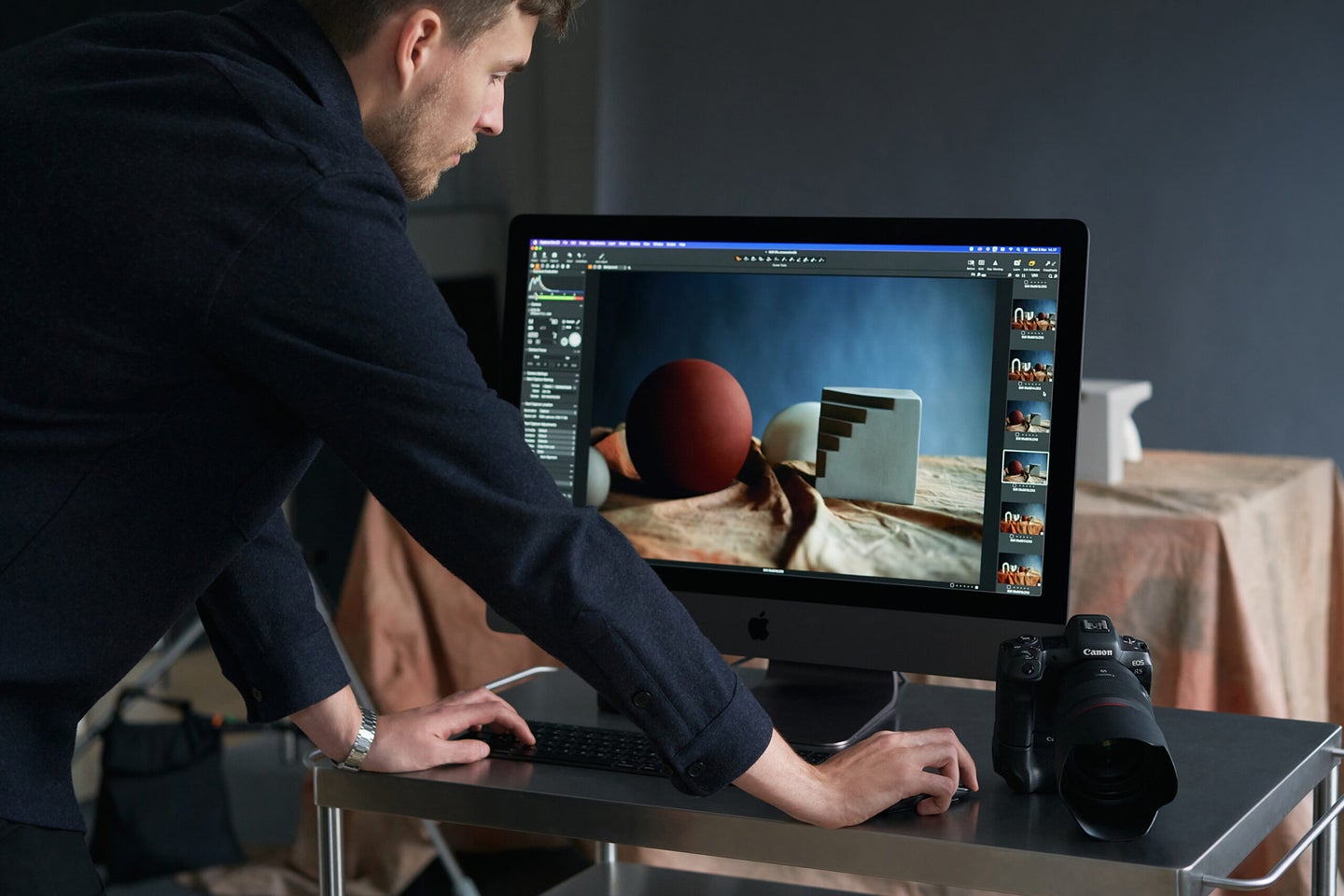 A man using Capture One Pro software on a desktop computer.