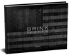 BRINK, by David Butow, is published by Punctum Books. The cover shot is a black-and-white treatment of a flag painted on the side of a barn.