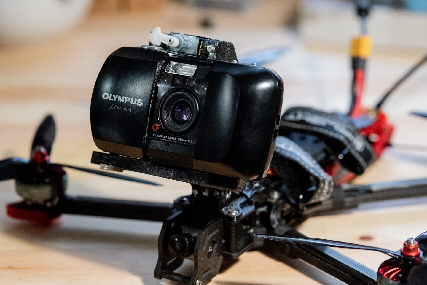 A drone with a film camera mounted to it