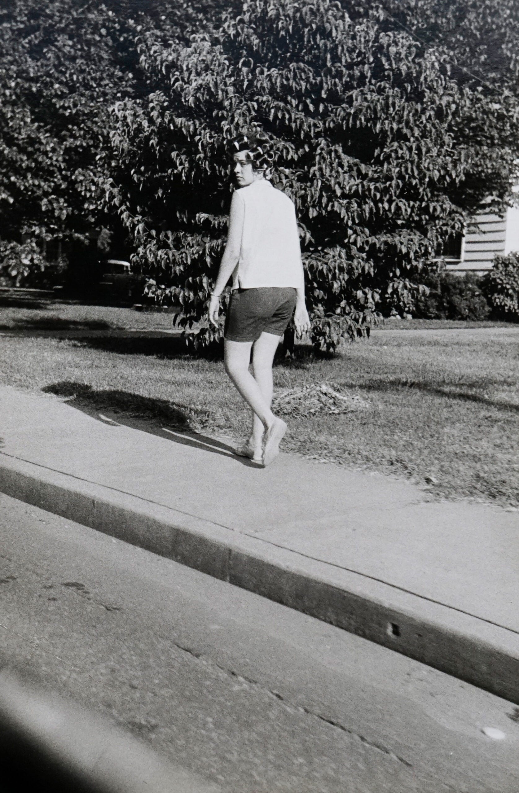 A William Eggleston B&W candid of a women walking