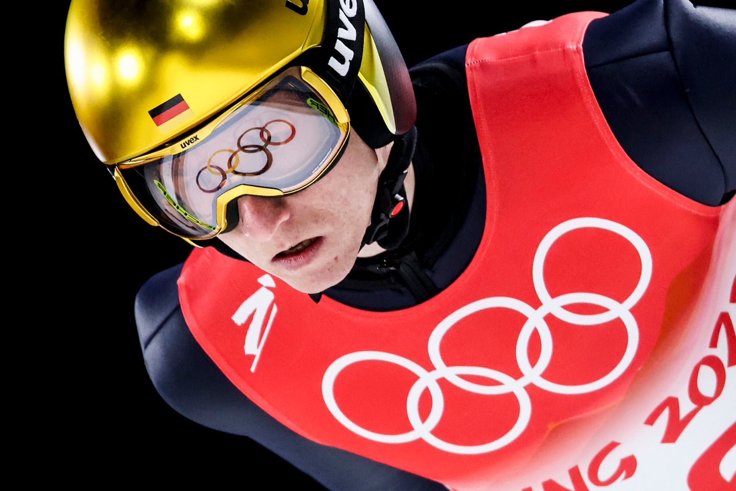 Olympic rings are reflected in Karl Geiger goggles during nordic ski jumping large hill, mens qualification event at the Beijing 2022 Winter Olympic Games.