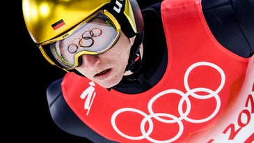 Olympic rings are reflected in Karl Geiger goggles during nordic ski jumping large hill, mens qualification event at the Beijing 2022 Winter Olympic Games.