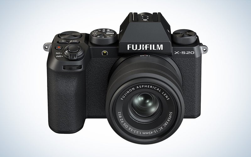 The black Fujifilm X-S20 mirrorless vlogging camera with lens attached against a white backround
