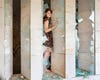 A portrait of a women from Lebanon in amongst shattered windows.