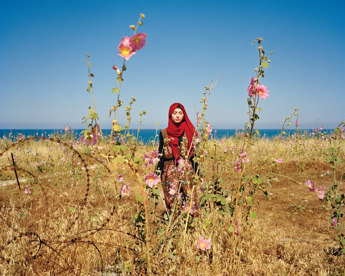 A portrait of a women from Lebanon in a field of flowers