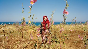 A portrait of a women from Lebanon in a field of flowers