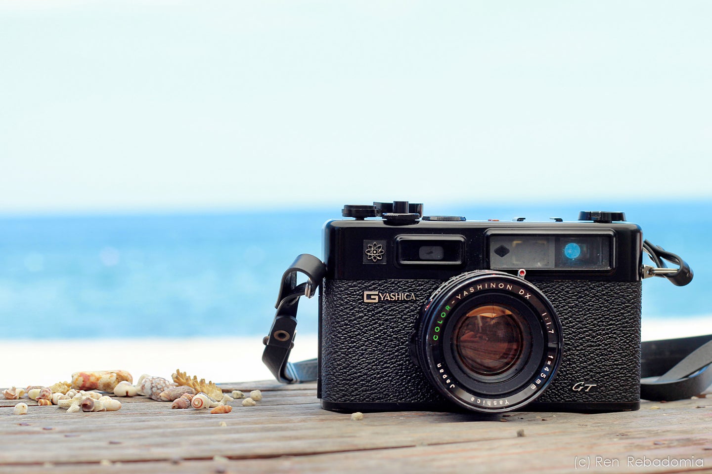 A rangefinder camera with a beach in the background.