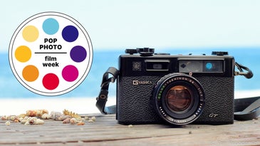 A rangefinder camera with a beach in the background.