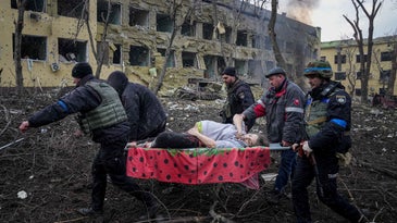 Ukrainian emergency employees and volunteers carry an injured pregnant woman from the damaged by shelling maternity hospital in Mariupol, Ukraine, Wednesday, March 9, 2022. A Russian attack has severely damaged a maternity hospital in the besieged port city of Mariupol, Ukrainian officials say.