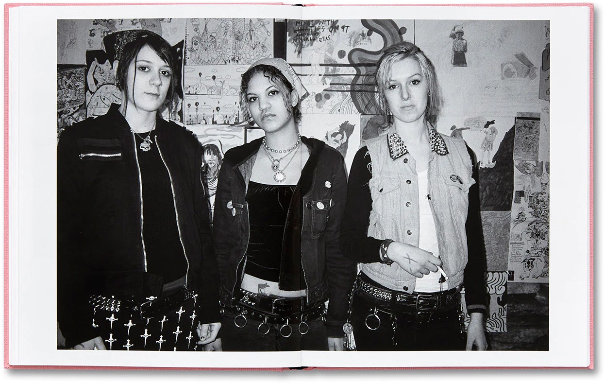 A B&W photo of three young women dressed in "punk" gear.