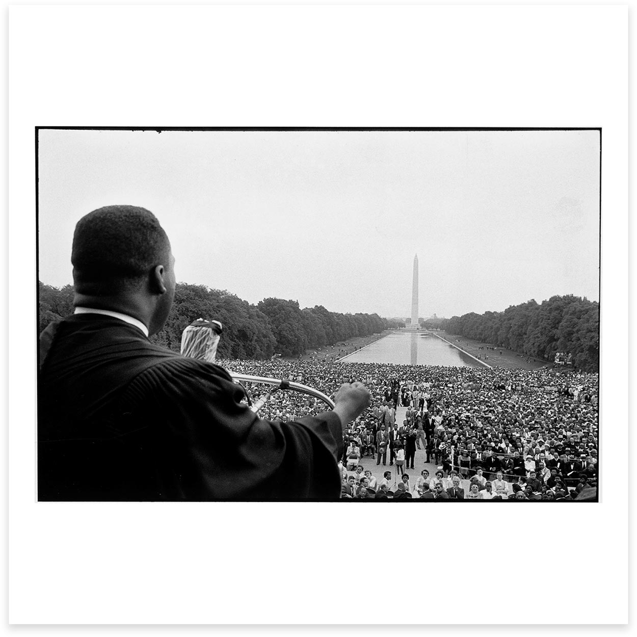 A photo of Dr. Martin Luther King speaking on the steps of the Lincoln Memorial.