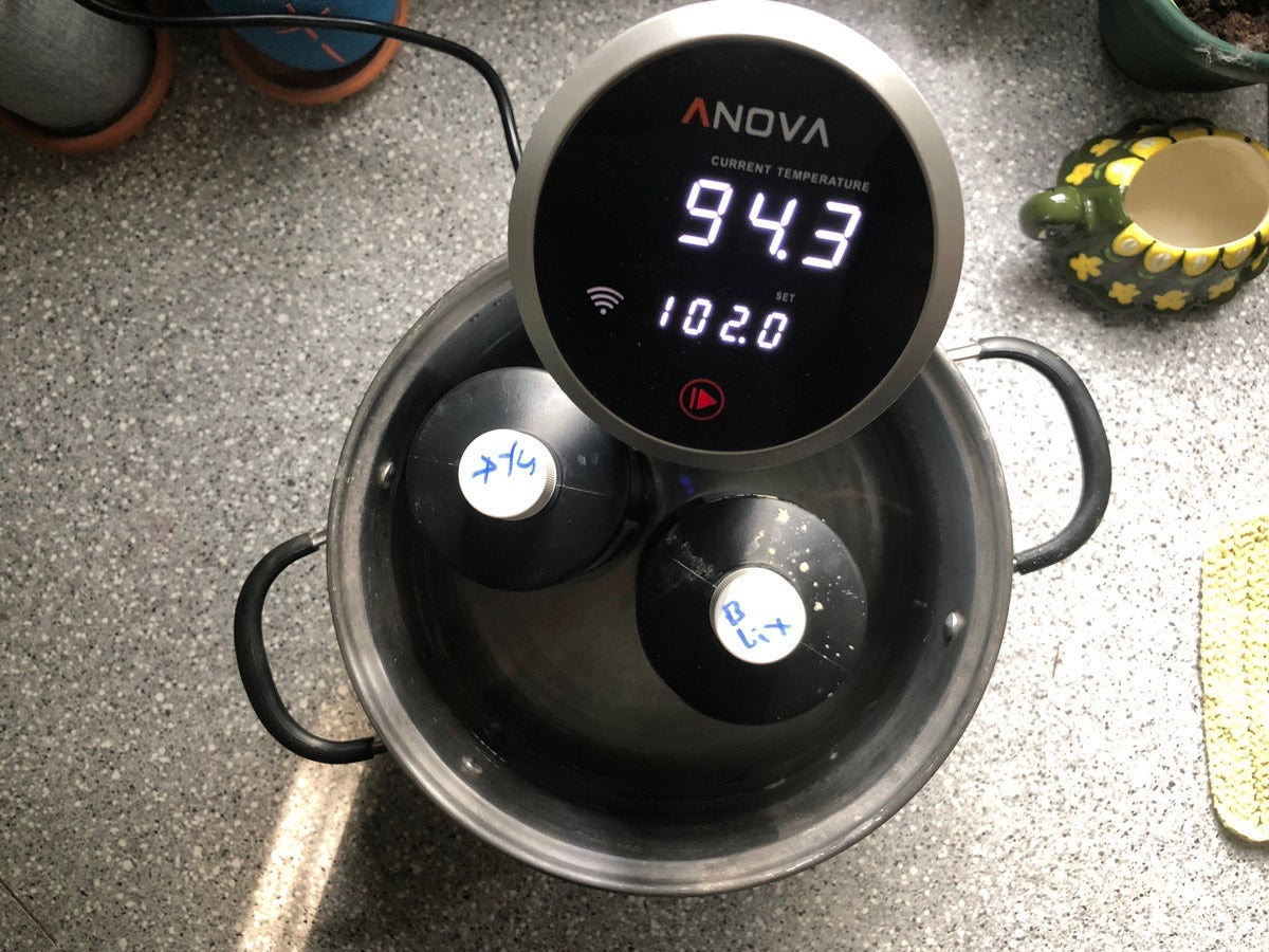 A souse vide machine heating up containers of photo chemicals.