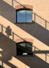 The shadow of a person on a beige wall.