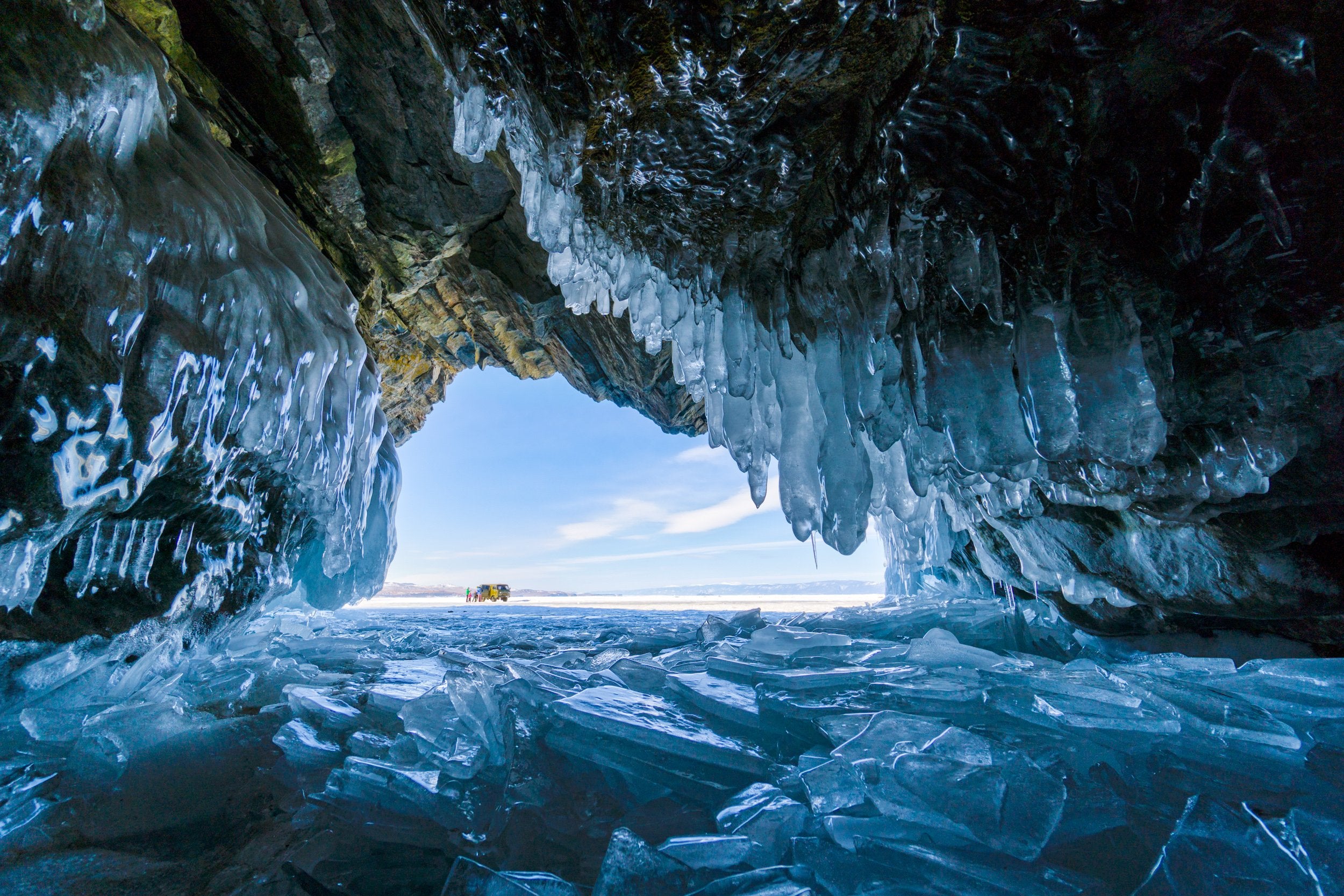 An icy cave looking out to the sky.