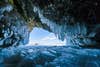 An icy cave looking out to the sky.