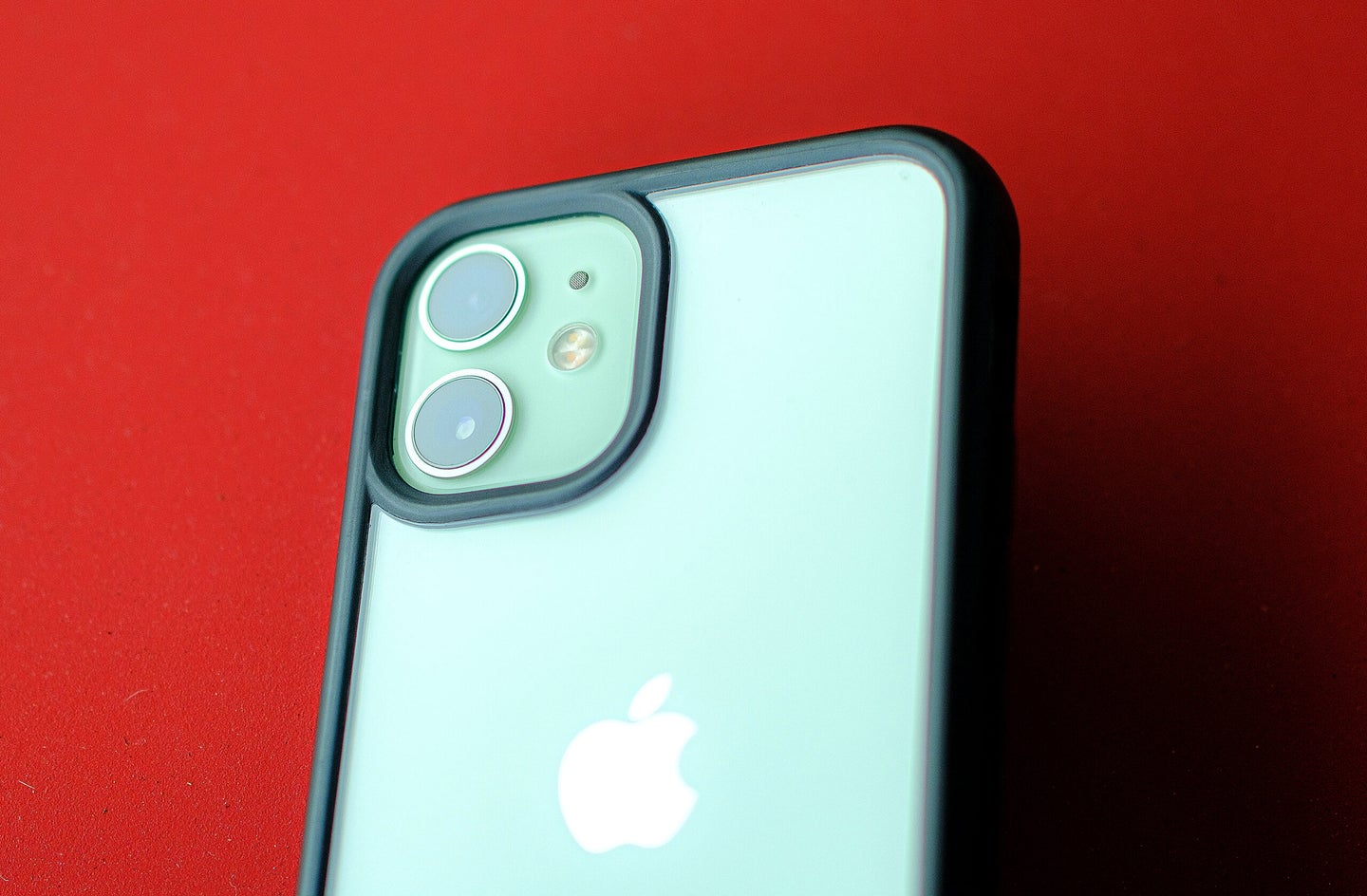 A green iPhone camera on a red background