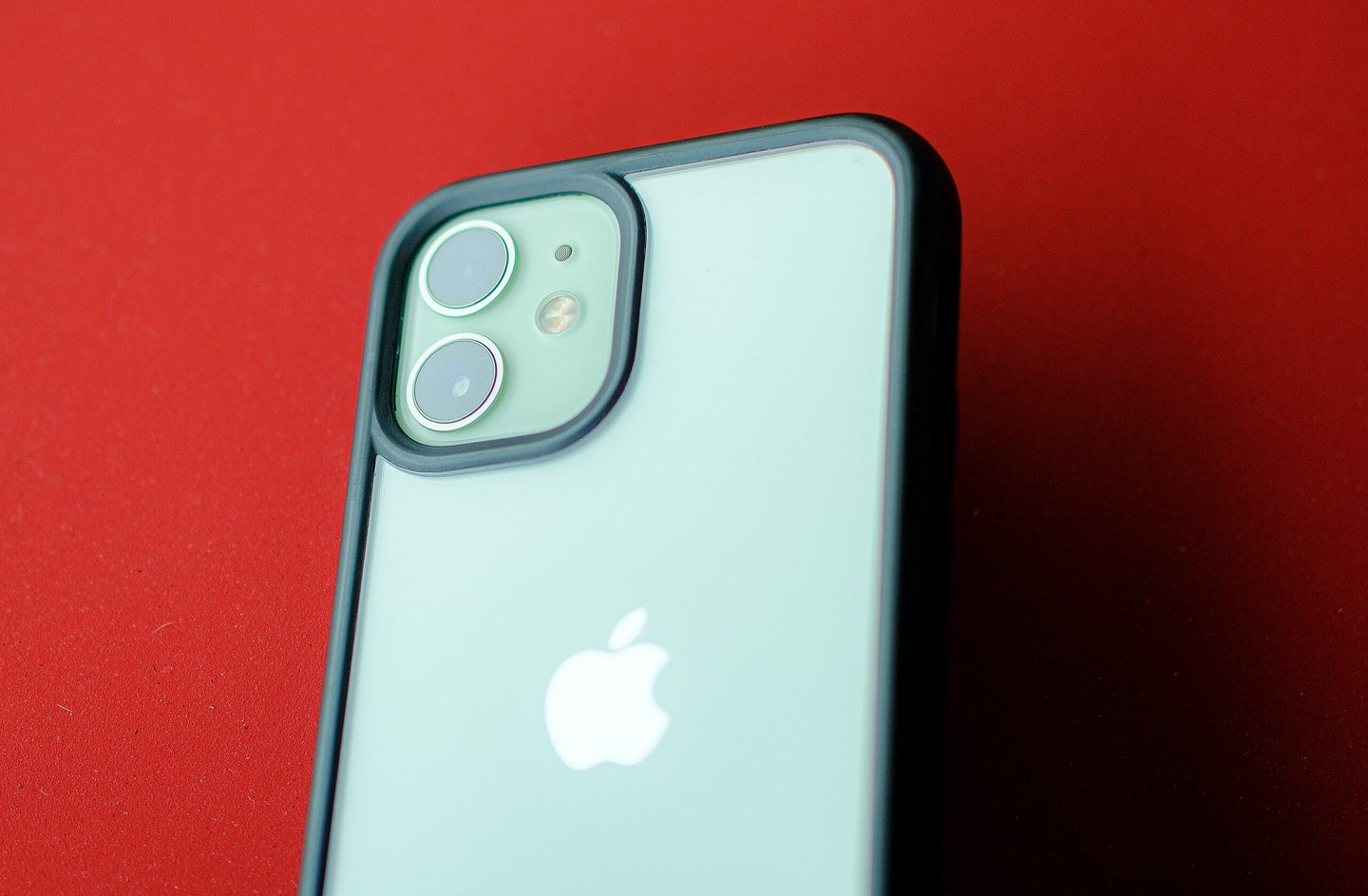 A green iPhone camera on a red background