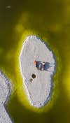 Portrait of a family seemingly sunbathing in the middle of a toxic lake.