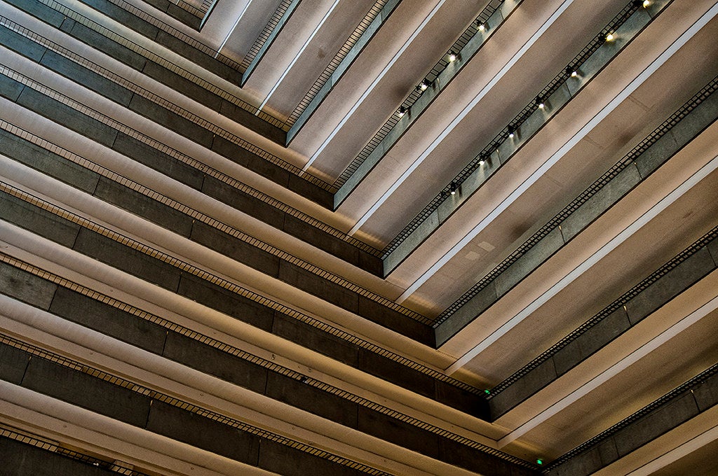 The inside of a hotel with repeating balconies.