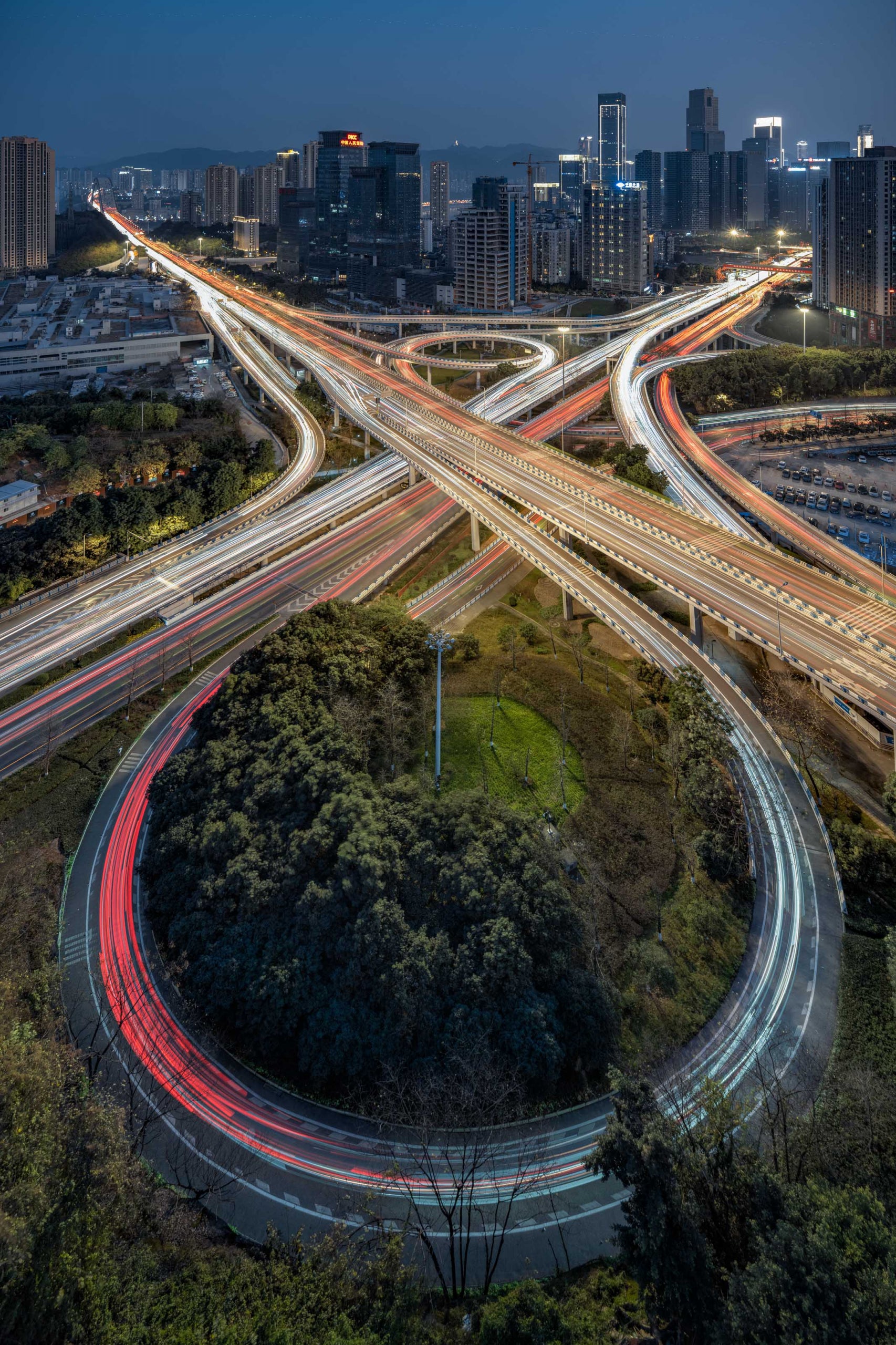 A long exposure sample of a city and highway with car light trails.