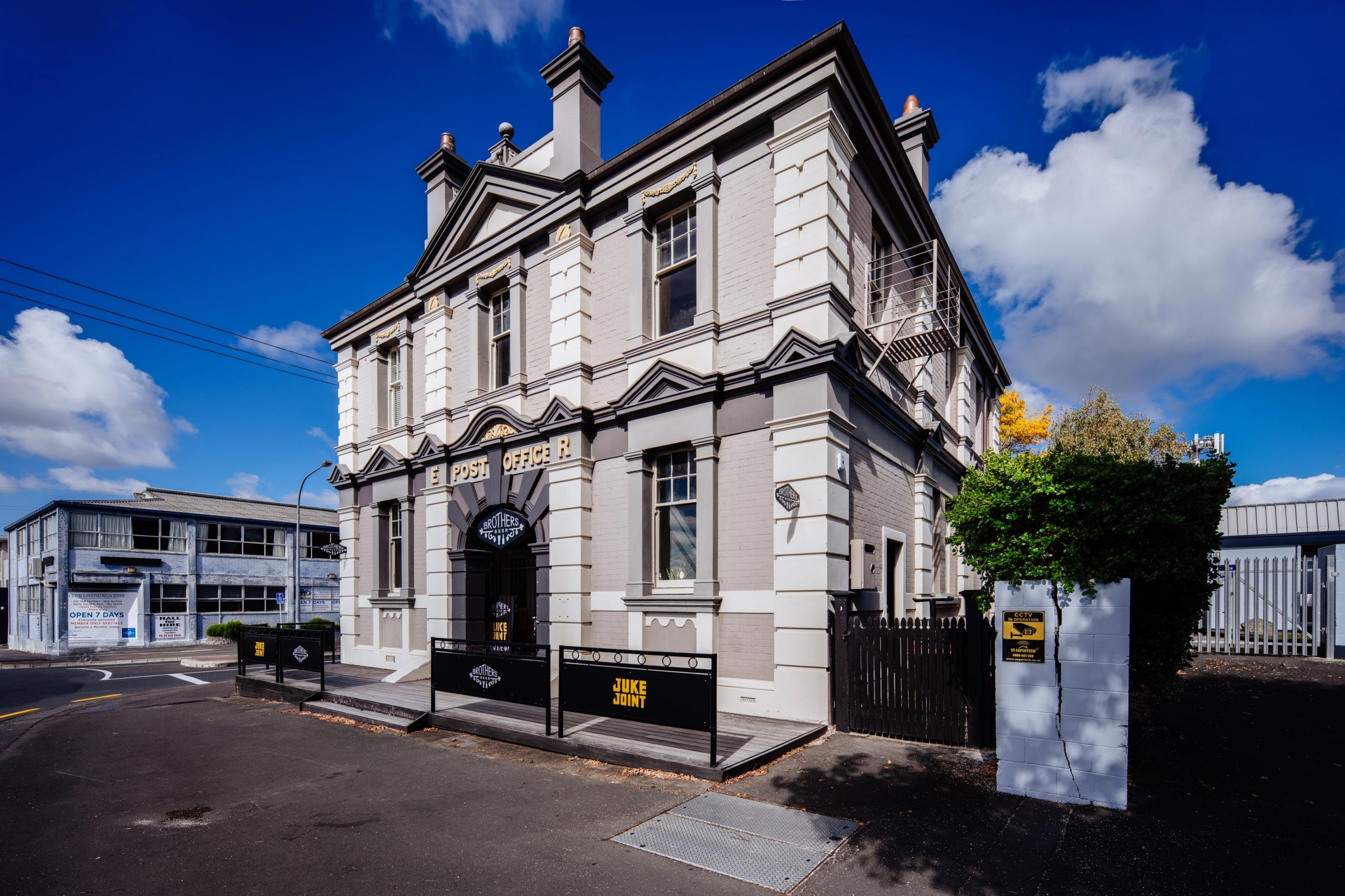 A sample showing a building with a blue sky and clouds.