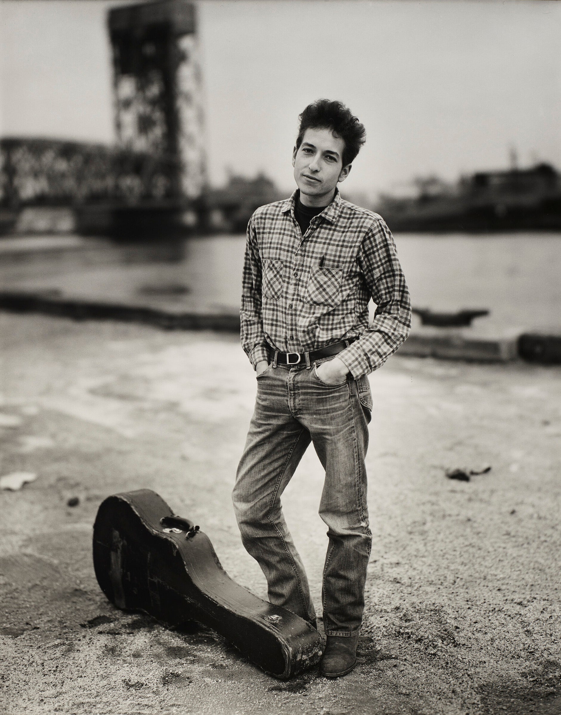 B&W portrait of Bob Dylan next to a guitar case by Richard Avedon.