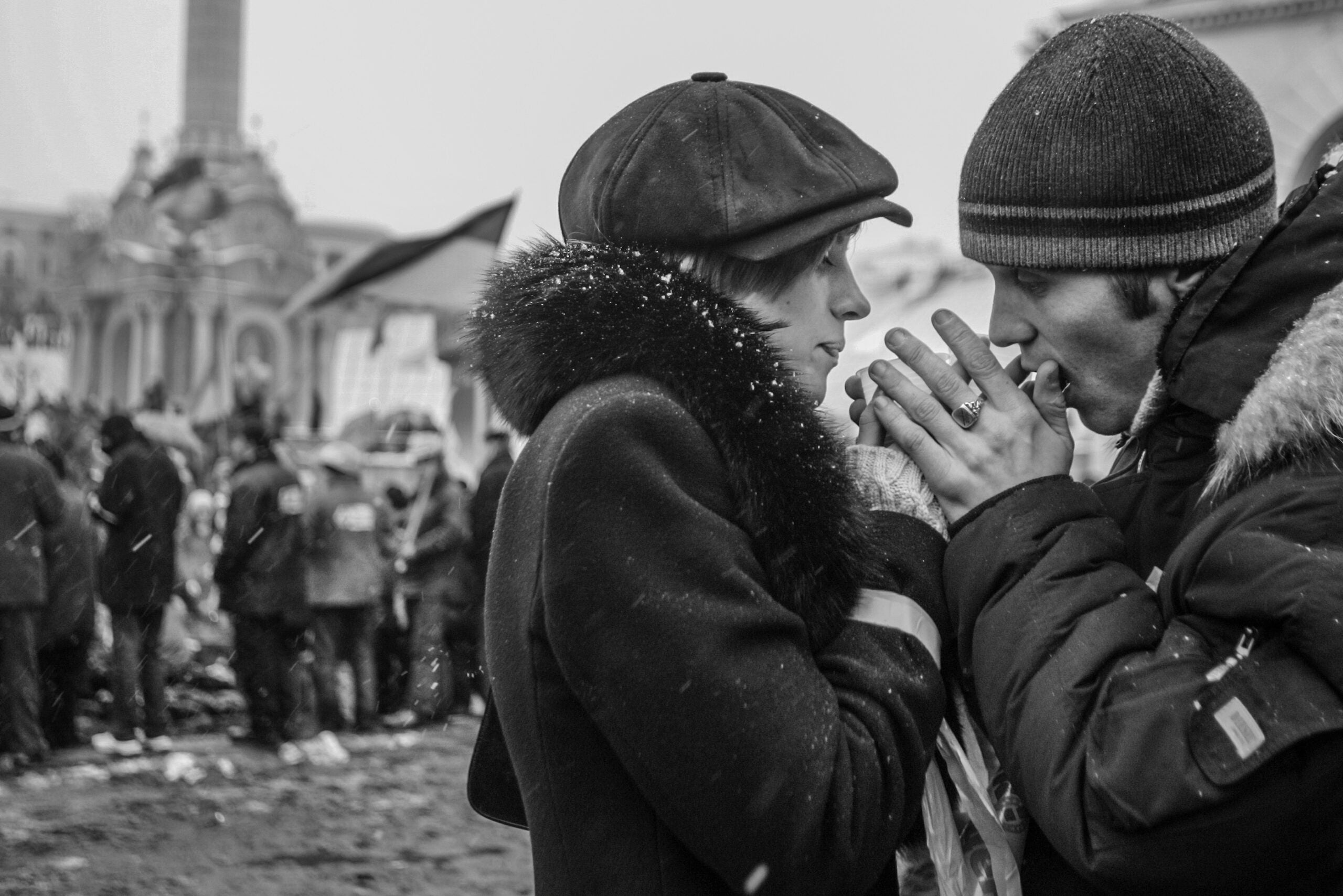 Warming one another’s hands in the bitter cold, a couple going fellow Ukrainian demonstrators on the main square in Kyiv, where thousands gathered to protest presidential election fraud.