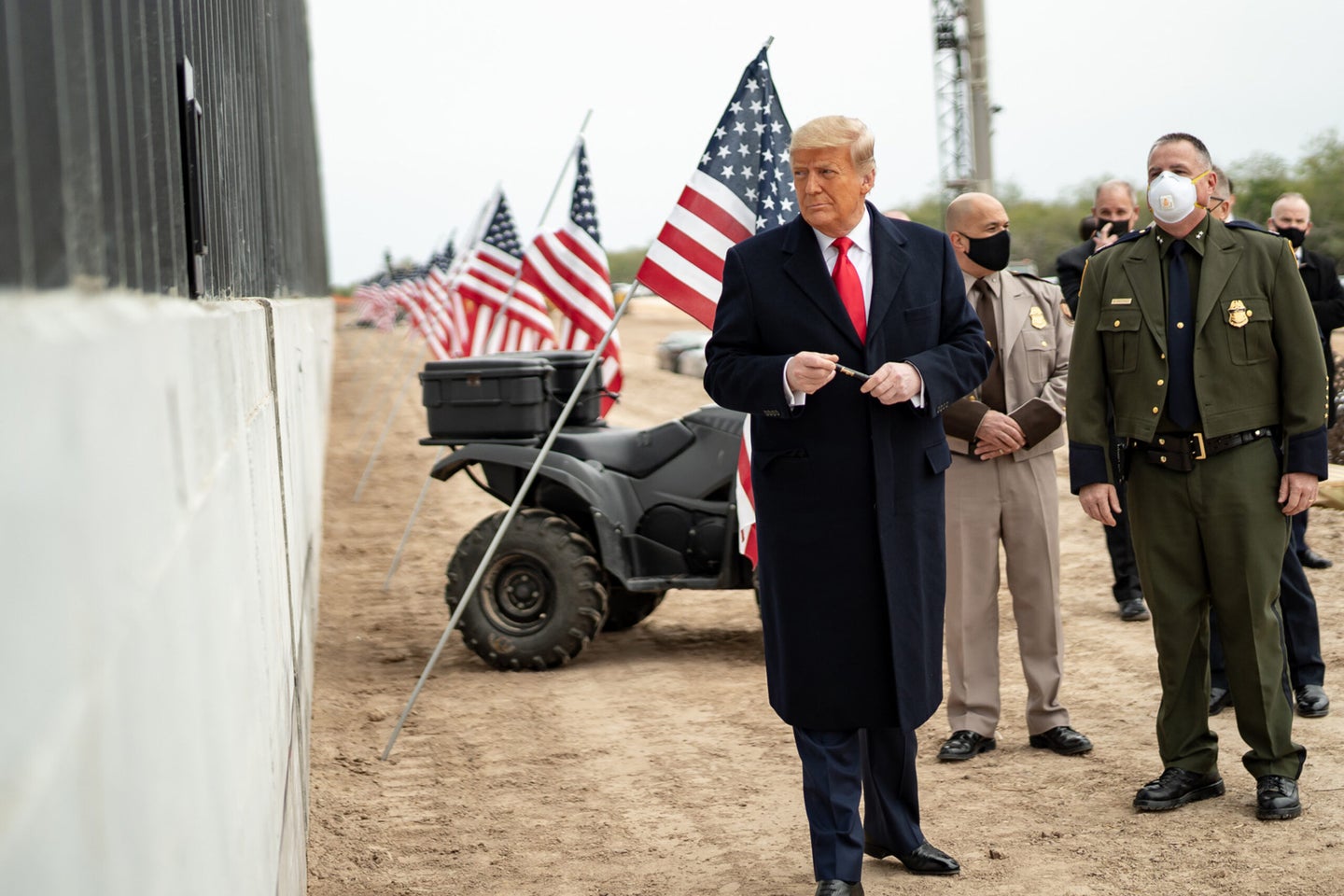 President Donald J. Trump prepares to sign a plaque placed along the border wall Tuesday, Jan. 12, 2021, at the Texas-Mexico border near Alamo, Texas.