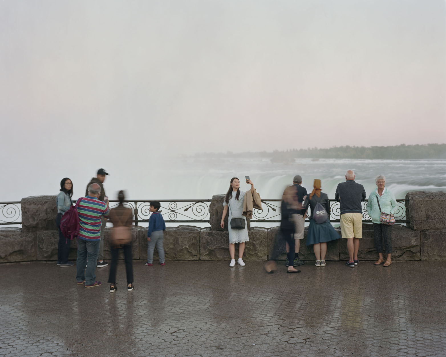 A crowd at Niagara Falls looking out at the water.