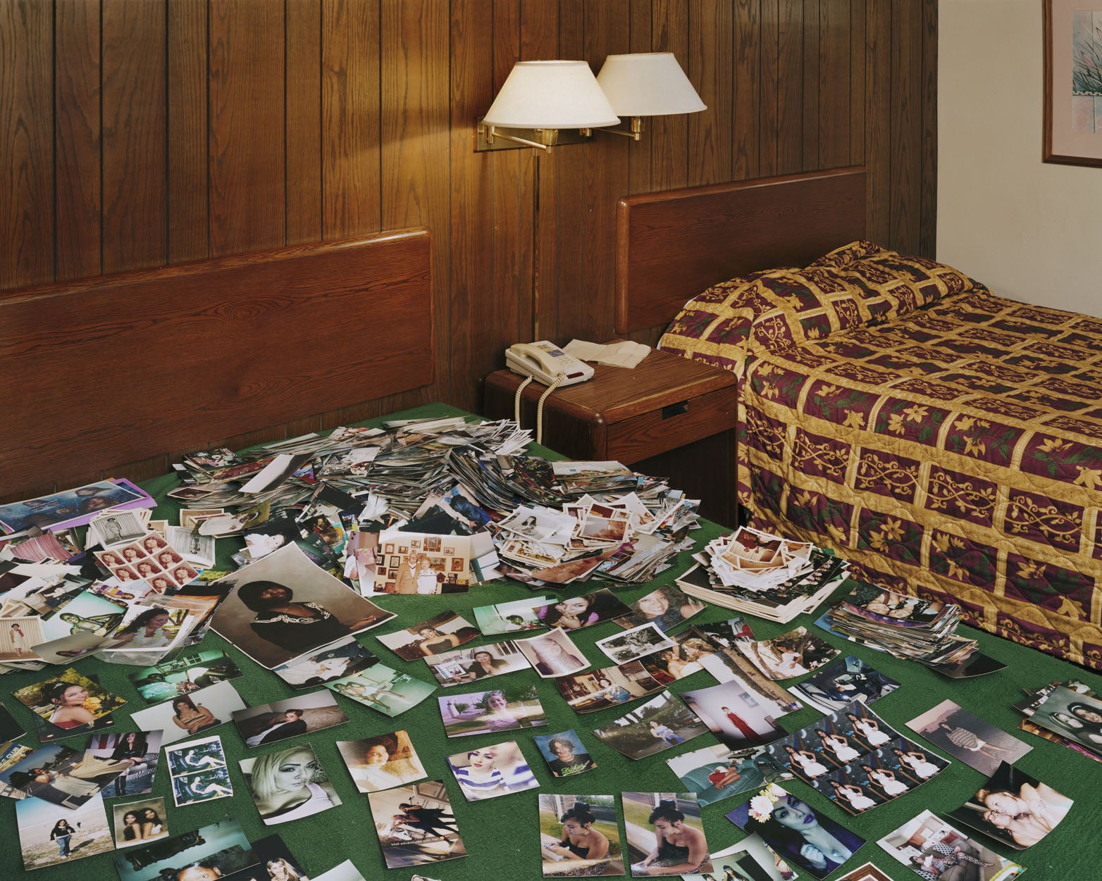 A motel room filled with photo prints.