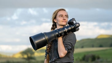 The new Nikon Z 800mm f/6.3 VR S in the hands of a female photographer.