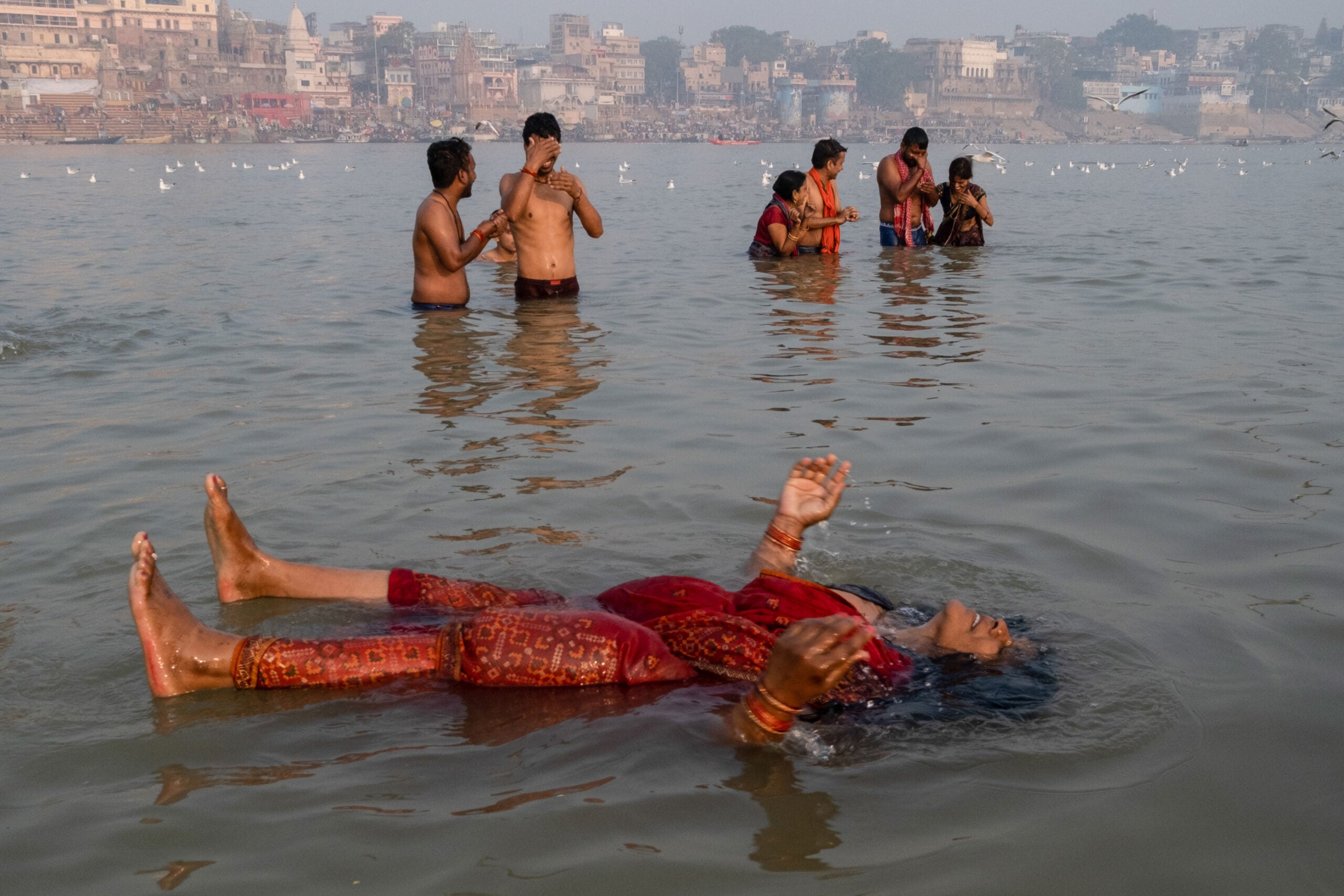 a woman floats on her back in a body of water