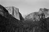 black and white photo of yosemite valley, el capitan, and half dome at sunset