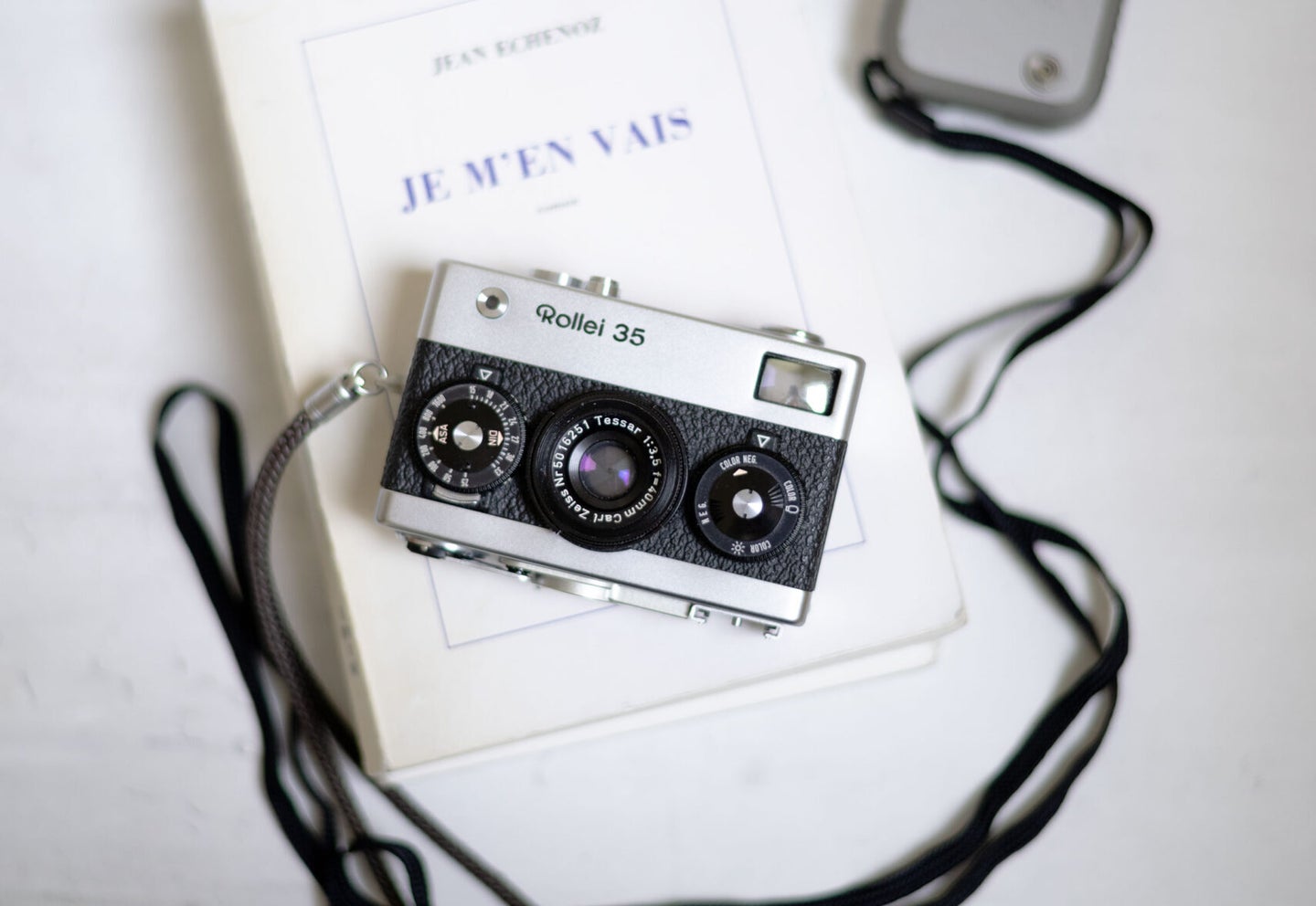 rollei35 camera sits on top of a french book and light meter