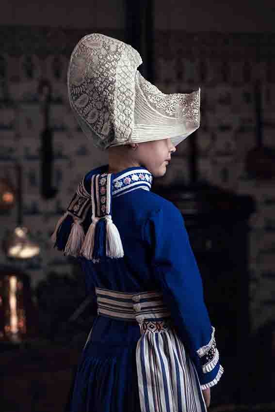 a dutch girl wears traditional dress 